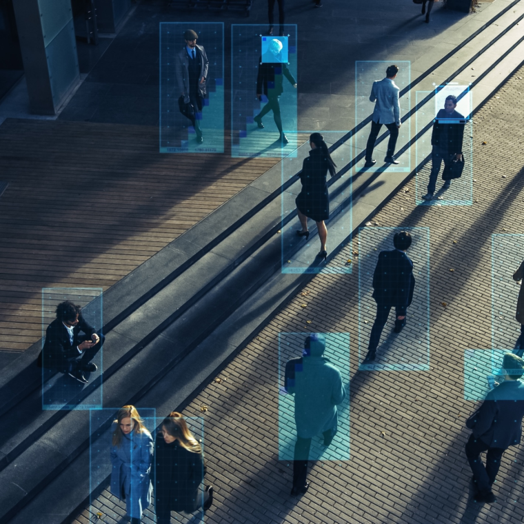 Elevated Security Camera Surveillance Footage of a Crowd of People Walking on Busy Urban City Streets. CCTV AI Facial Recognition Big Data Analysis Interface Scanning, Showing Personal Information.