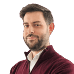 Dark-haired man wearing a dark red sweater and a white shirt