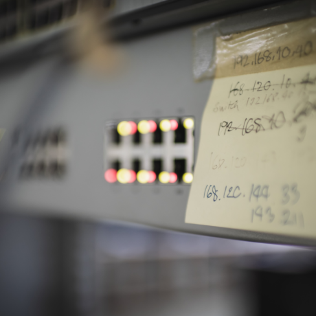 Close up of rack network switch with indication light bokeh and notepad with generic ip address written on it