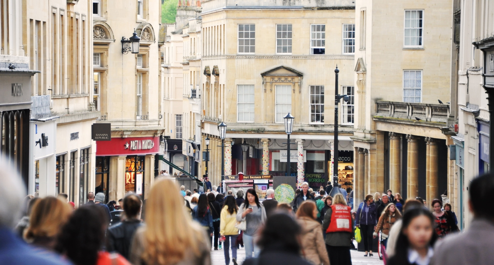 BATH, UK - MAY 1, 2014: Crowds of people walk along a busy city centre street. The landmark Somerset UNESCO World Heritage city is popular travel destination with over 4 million visitors per year.